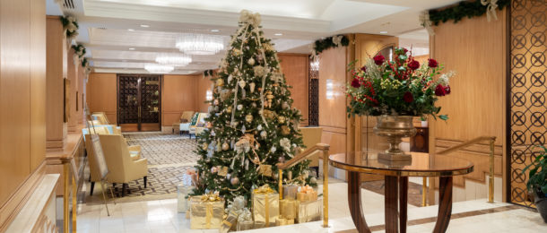 The Rittenhouse hotel lobby decorated with a Christmas tree, garland, and flowers