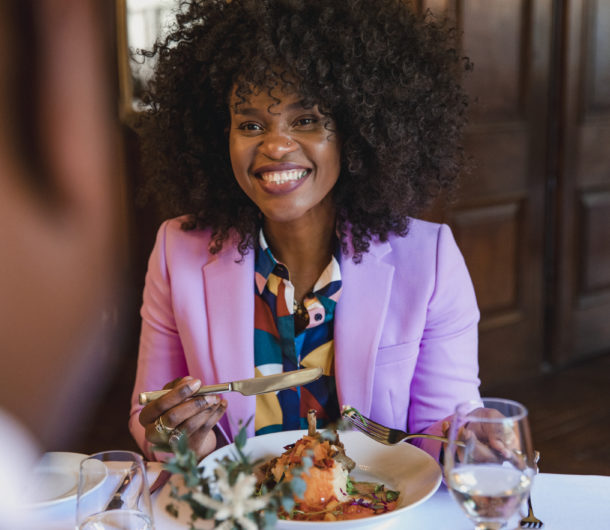 A woman smiling while dining out at a hotel restaurant